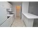 Efficient kitchen features white appliances and cabinets with an open pantry and breakfast bar at 1400 Gandy N Blvd # 1705, St Petersburg, FL 33702