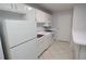 Bright kitchen showcases white cabinets, appliances, tile backsplash, and breakfast bar at 1400 Gandy N Blvd # 1705, St Petersburg, FL 33702