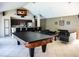Spacious living area with tile flooring, pool table, seating, kitchen, and a wall-mounted TV at 1400 Gandy N Blvd # 1705, St Petersburg, FL 33702