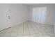 Bright living area with neutral tile flooring and a door at 1400 Gandy N Blvd # 1705, St Petersburg, FL 33702