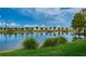 Scenic pond view with grassy shoreline and reflections of the blue sky and trees at 1400 Gandy N Blvd # 1705, St Petersburg, FL 33702