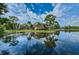 Scenic view of apartment buildings reflected in the calm waters of a pond, with lush green surroundings at 1400 Gandy N Blvd # 1705, St Petersburg, FL 33702