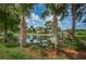 Serene pond surrounded by lush landscaping and palm trees in the community at 1400 Gandy N Blvd # 1705, St Petersburg, FL 33702