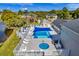 Inviting community pool area with lounge chairs, tables, umbrellas, and a relaxing jacuzzi at 1400 Gandy N Blvd # 1705, St Petersburg, FL 33702