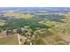 An aerial perspective reveals the property's location among trees, fields, and neighboring houses, close to the area at 14409 Curley Rd, Dade City, FL 33525