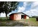Sturdy barn structure with metal siding on a green lawn area provides plenty of storage space at 14409 Curley Rd, Dade City, FL 33525