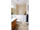 Accessible bathroom featuring walk-in tub, tiled walls, and vanity with modern fixtures at 14409 Curley Rd, Dade City, FL 33525