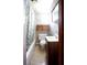 Cozy bathroom featuring a shower-tub combo and quaint vanity with bright natural light at 14409 Curley Rd, Dade City, FL 33525