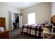 Cozy bedroom featuring comfortable bed, large window, closet, and carpeted floors at 14409 Curley Rd, Dade City, FL 33525