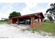 Brick and concrete carport with multiple bays offering sheltered parking on a spacious property at 14409 Curley Rd, Dade City, FL 33525