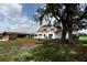 Charming two-story home features a well-manicured yard and mature shade tree at 14409 Curley Rd, Dade City, FL 33525