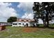 Charming two-story home features a well-manicured yard and mature shade tree at 14409 Curley Rd, Dade City, FL 33525