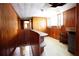 Upstairs hallway features wood paneling, unique shelving, and access to multiple rooms, leading downstairs at 14409 Curley Rd, Dade City, FL 33525