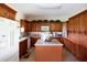 Updated kitchen with wood cabinets, granite countertops, and a center island at 14409 Curley Rd, Dade City, FL 33525