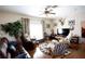 Comfortable living room with ceiling fan, hard floors, deer head art piece and a large window at 14409 Curley Rd, Dade City, FL 33525