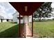 Covered walkway leading to the home offers a peek at the charming exterior and yard at 14409 Curley Rd, Dade City, FL 33525