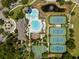 Aerial view showcasing a community pool, tennis courts, basketball court, and surrounding landscaping at 14634 Mirasol Manor Ct, Tampa, FL 33626