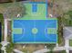 A top-down look at the dual basketball court with bright blue and green surfaces in a sunny neighborhood at 14634 Mirasol Manor Ct, Tampa, FL 33626