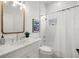 Bathroom featuring shower-tub combo, modern sink, and contemporary art piece at 14634 Mirasol Manor Ct, Tampa, FL 33626