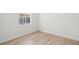 Bright bedroom featuring wood floors and a window with white blinds at 14634 Mirasol Manor Ct, Tampa, FL 33626