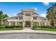 Well-maintained community clubhouse with a covered entrance, lush landscaping, and a paved walkway leading to the entrance at 14634 Mirasol Manor Ct, Tampa, FL 33626