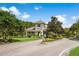 Elegant community entrance with a gatehouse, well-maintained landscaping, and a paved road leading into the neighborhood at 14634 Mirasol Manor Ct, Tampa, FL 33626