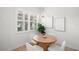 Bright dining area with wood table, comfortable seating, and natural light from the window at 14634 Mirasol Manor Ct, Tampa, FL 33626