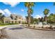 Stately home with a circular driveway, fountain, palm trees, and manicured landscaping under a clear, blue sky at 14634 Mirasol Manor Ct, Tampa, FL 33626