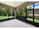 Enclosed lanai with views of the lush backyard and greenery at 14634 Mirasol Manor Ct, Tampa, FL 33626