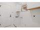 Clean laundry room features a utility sink with white cabinets and marble floors at 14634 Mirasol Manor Ct, Tampa, FL 33626