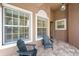 Covered patio with tile floors and comfortable seating area at 14634 Mirasol Manor Ct, Tampa, FL 33626