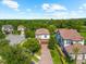 Beautiful aerial view of homes with tile roofs and mature trees on a sunny day at 1570 Marinella Dr, Palm Harbor, FL 34683
