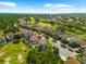 High aerial view of a golf community with homes, landscaping and beautiful blue skies at 1570 Marinella Dr, Palm Harbor, FL 34683