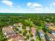 Aerial view showcasing the neighborhood's proximity to lush landscaping and a golf course at 1570 Marinella Dr, Palm Harbor, FL 34683
