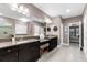 A spacious bathroom features granite counters with double sinks, a tub, glass enclosed shower, and a toilet at 1570 Marinella Dr, Palm Harbor, FL 34683
