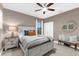 A spacious bedroom with carpeted floors, a ceiling fan, a window with blinds, and neutral paint at 1570 Marinella Dr, Palm Harbor, FL 34683