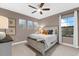 A charming bedroom with carpeted floors, a ceiling fan, a window with blinds, and neutral paint at 1570 Marinella Dr, Palm Harbor, FL 34683