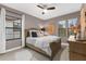 A charming bedroom with carpeted floors, a ceiling fan, multiple windows with blinds, and neutral paint at 1570 Marinella Dr, Palm Harbor, FL 34683