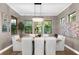 Elegant dining room with a chandelier, large windows, and seating for eight at 1570 Marinella Dr, Palm Harbor, FL 34683