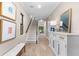 Inviting hallway with a staircase, neutral walls, decorative furniture, and wood-look flooring, creating a warm welcome at 1570 Marinella Dr, Palm Harbor, FL 34683