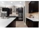 Modern kitchen with stainless steel appliances, dark cabinets and light countertops, creating a clean and bright space at 1570 Marinella Dr, Palm Harbor, FL 34683