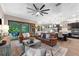 Spacious living room flows into kitchen, featuring a ceiling fan and sliding glass doors to the outside at 1570 Marinella Dr, Palm Harbor, FL 34683