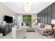 Elegant living room with a stylish sofa, patterned ottoman, and a modern entertainment center at 1570 Marinella Dr, Palm Harbor, FL 34683