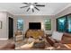 Cozy living room with a large TV and views of the landscaped outdoors at 1570 Marinella Dr, Palm Harbor, FL 34683
