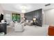 Comfortable living room with panel accent wall, stylish furniture, and access to an outdoor balcony at 1570 Marinella Dr, Palm Harbor, FL 34683