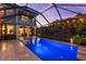 Screened pool view highlighting outdoor entertaining space, pool details, and a glimpse of the home's interior at 1570 Marinella Dr, Palm Harbor, FL 34683