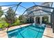 Relaxing screened-in pool with lounge chairs and manicured landscaping at 1570 Marinella Dr, Palm Harbor, FL 34683
