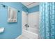 Clean bathroom with white tile and a blue shower curtain at 16011 Saddle Creek Dr, Tampa, FL 33618