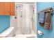 A tiled bathroom with a shower, cabinet, and toilet at 16011 Saddle Creek Dr, Tampa, FL 33618