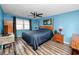 Bright bedroom with a ceiling fan, wood-look floors, and two side tables at 16011 Saddle Creek Dr, Tampa, FL 33618